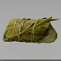 Traditional Chinese Zongzi Wrapped in Green Bamboo Leaves and Tied with String on Dark Glossy Surface