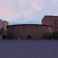 Rusted Circular Building With Surrounding Old Buildings Square People And Trees