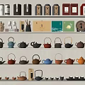 Variety of Tea Sets Display with Colorful Teapots Cups and Tea Canisters on Shelves