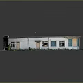 Single Story Building Exterior With Gray Roof Windows And Green Plants