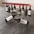 Several Wine Bottles And Two Wine Glasses On Gray Countertop With Wine Rack