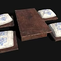 Wooden Dining Table With Four Cushions Featuring Blue And White Floral Patterns