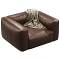 Elegant Brown Leather Single Sofa With Cozy Gray Blanket In Living Room