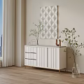 White Console Cabinet with Drawers Gold Trim Potted Plants and Textured Wall Art