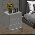 Stylish White Three Drawer Nightstand In Bedroom With Vase Yellow Flowers And Photo Frames