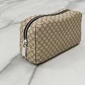 Beige Toiletry Bag With Classic Double G Pattern Black Zipper Silver Pull On Marble Surface
