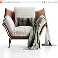 Modern Brown Leather Armchair With Light Gray Fabric Cushions And Green Throw Blanket