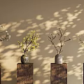 Decorative Vases With Flowers On Wooden Pillars Against Wall With Light Shadow Effects
