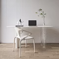 Modern White Oval Table and Chair Set With Laptop Green Plant and Decor
