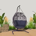Outdoor Black Woven Hanging Chair With Blue Cushion Green Plants And Stone Decor