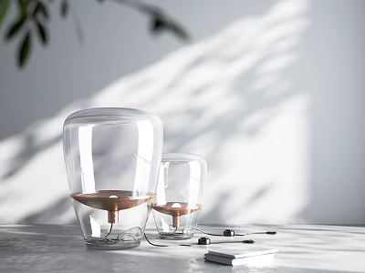 Two Transparent Glass Table Lamps With Copper Base On Gray Tabletop And Soft Light Shadow 3d model