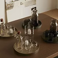 Decorative Metal Trays With Glass Bottles Cups And Candles On Wooden Table
