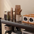 Organized Kitchen Appliances on Multi Tiered Shelving with Microwave Coffee Maker and Storage Jars