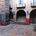 European Style Architecture With Stone Arches Staircase Balconies And Paved Courtyard