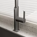 Contemporary Kitchen Sink Featuring Sleek Faucet And Window Blinds On Countertop