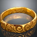 Golden Decorative Ring With Intricate Carved Patterns And Shiny Surface