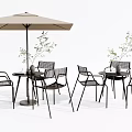 Modern Outdoor Table Set With Sleek Metal Chairs Large Umbrella And Potted Greenery