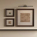 Abstract Painting in Brown Frame with Two Smaller Brown Frames and Wall Lamp on Beige Wall