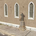 Traditional Church Building With Steeple Tower Brown Exterior Gray Roof Round Window And Arched Doorway