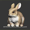 Brown Rabbit Sculpture Sitting On Gray Pad With Detailed Ears And Eyes