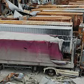 Old Abandoned Trucks Stacked In Dilapidated Ruins With Scattered Rusty Wreckage