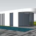 Modern Entrance Gate With Glass Structure Surrounded by Palm Trees and Lush Greenery