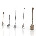 Metallic Spoons In Various Sizes And Shapes Arranged On White Background