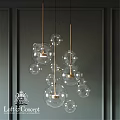 Elegant Contemporary Glass Ball Chandelier with Gold Metal Frame Against Dark Gray Wall