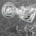Burned Motorcycle Remains With Debris And Ash On Gravel Ground
