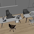 Modern Office Desks with Computers and Various Colored Chairs in Bright Workspace with Wooden Floor
