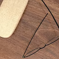 Beige Glasses Case And Black Eyeglasses Placed On Wooden Table Top
