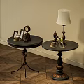 Vintage Round Tables With Metal Bases And Decorative Clock Lamp Sculpture On Wooden Floor