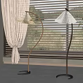 Modern Curved Floor Lamps With White Shades Near Window Blinds And Green Plant