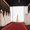 Elegant Bridal Shop Featuring Wedding Dresses On Hangers Red Carpet Mannequin And Bright Interior