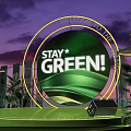 Green Themed Stage With Stay Green Sign And Plant Decorations At Night