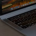 Modern Laptop With Scenic Screen On Wooden Desk With Black Headphones Books And Potted Plants