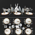 Elegant White Dinnerware Set With Gold Accents Cutlery Glassware And Decorative Figurines