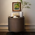 Round Wooden Bedside Table with White Teapot Cup Plant Vase and Wall Framed Flower Painting