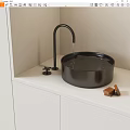 Modern Black Bathroom Sink With Dripping Faucet On White Countertop And Soap Bars