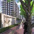 Modern High Rise Building Exterior With Glass Windows Green Trees And Decorative Wall