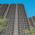 Modern Tall High Rise Apartment Building With Evening Window Lights And Green Trees