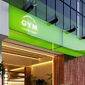 Green Signage Gym Entrance Design With Glass Facade And Lighting Features