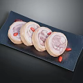 Panda Shaped Roll Cakes on Black Plate with Red Goji Berries