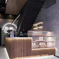 Modern Café Interior Featuring Wooden Counter Glass Display Case Fresh Pastries Staircase And Neon Lighting