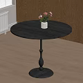 Round Black Dining Table With White Vase And Colorful Flowers On Wooden Floor
