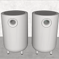 Two White Cylindrical Speakers With Round Speaker Holes And Small Feet At Bottom