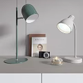 Modern Green And White Desk Lamps With Book Camera And Candle On Table