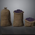 Three Burlap Sacks Filled with Fresh Purple Fruits on Dark Surface