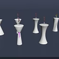 White Decorative Pillars With Small Flowers And Colored Ribbons On Dark Background