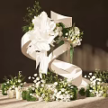 Elegant Romantic Floral Decoration With White Flowers Green Foliage White Ribbon And Small Bouquets